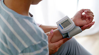 Still Image of Caring Mother Measures Sons Pulse And Blood Pressure On Digital Tonometer Close Up