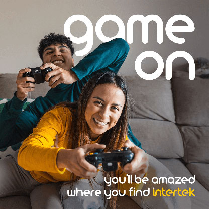 Man and woman on a couch with game controllers